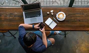 man with devices nd coffee