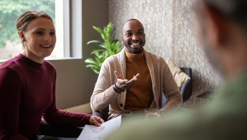 Creative african businessman smiling and chatting casually with 