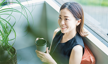 woman looking at inclusivity audit with coffee
