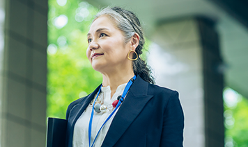 woman looking at inclusivity audit with coffee