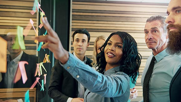 woman looking at inclusivity audit with coffee